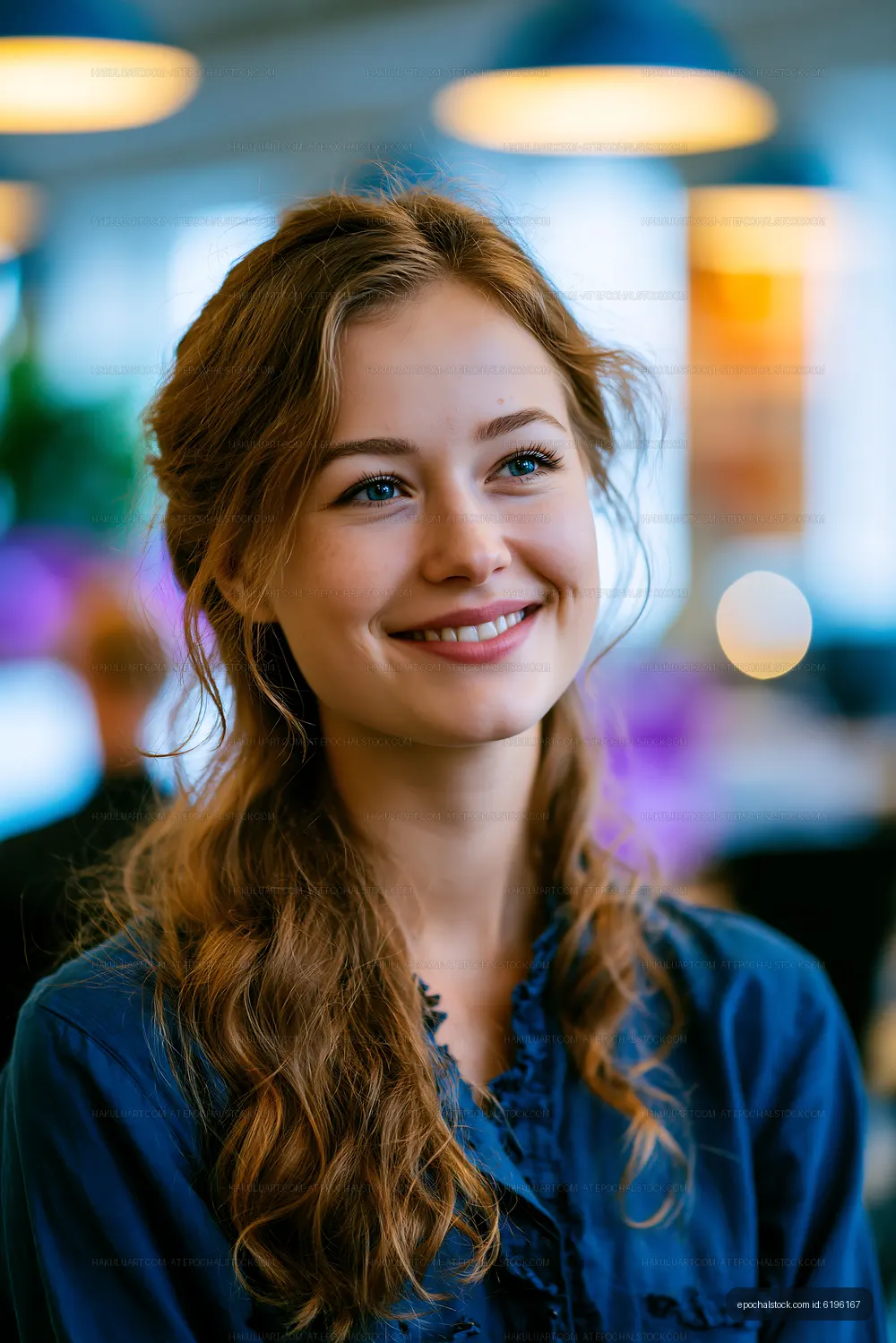 Young woman smiling in a modern workspace during daylight hours