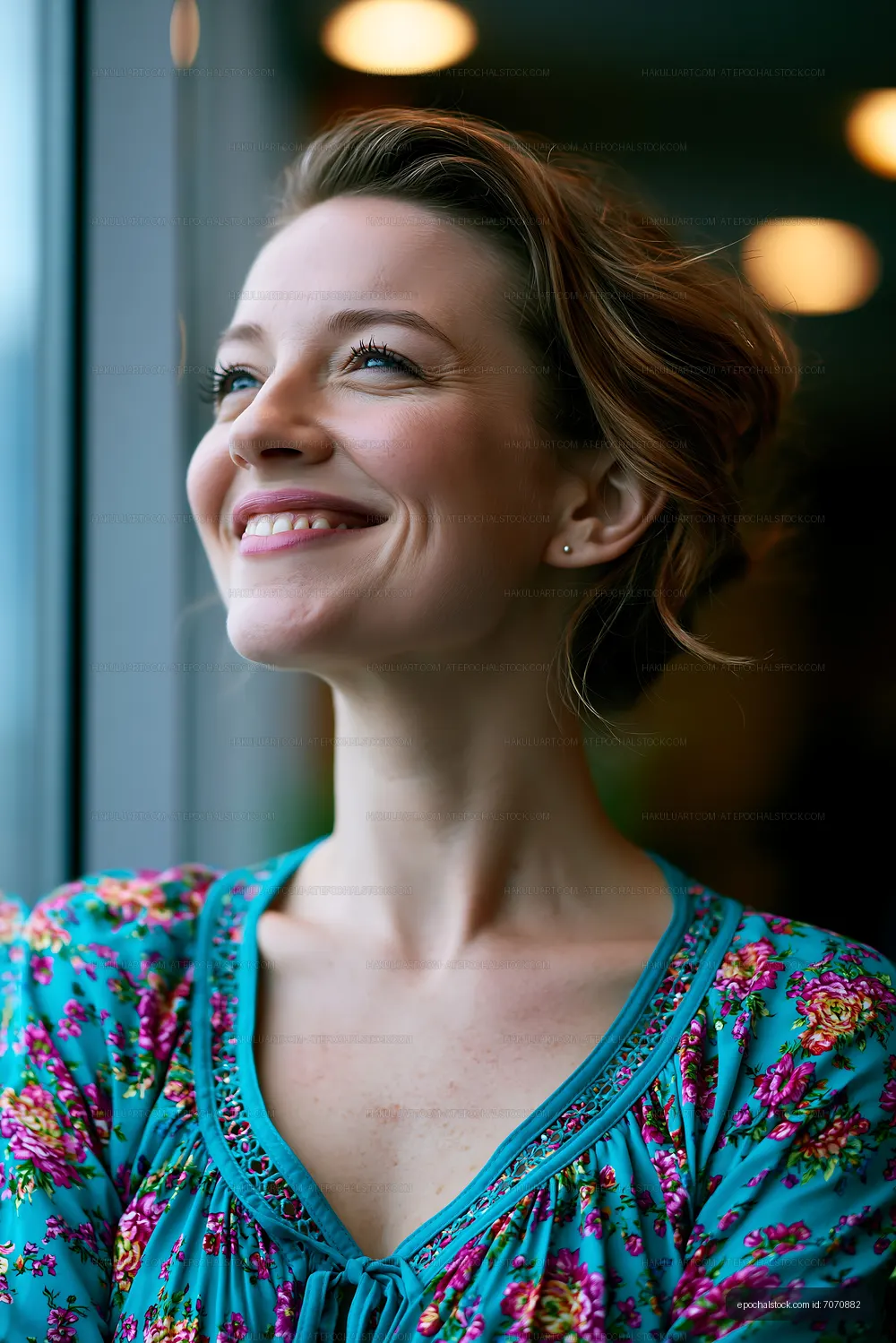 Woman smiling while looking out a window in a modern setting