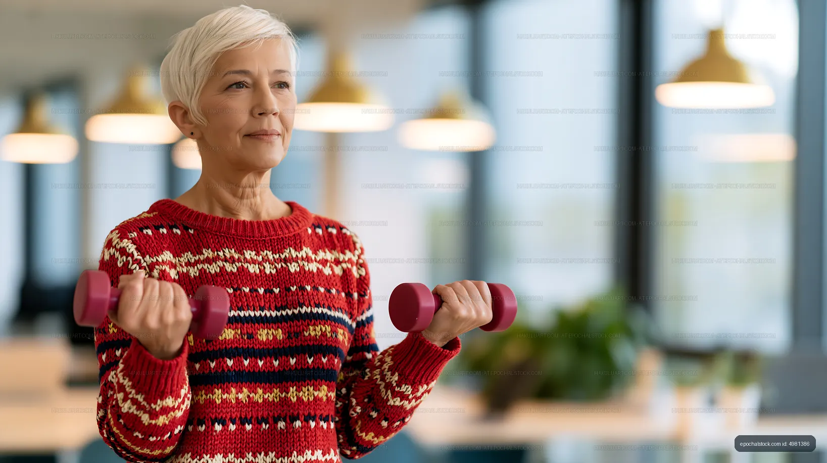 Woman exercising with dumbbells in modern office space