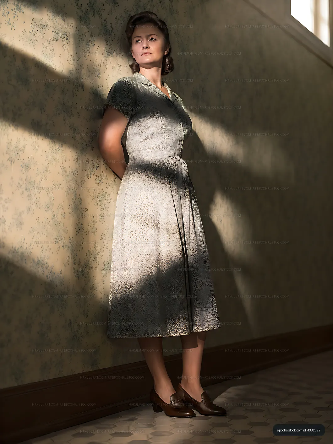 Woman standing against a wall in vintage dress with natural light
