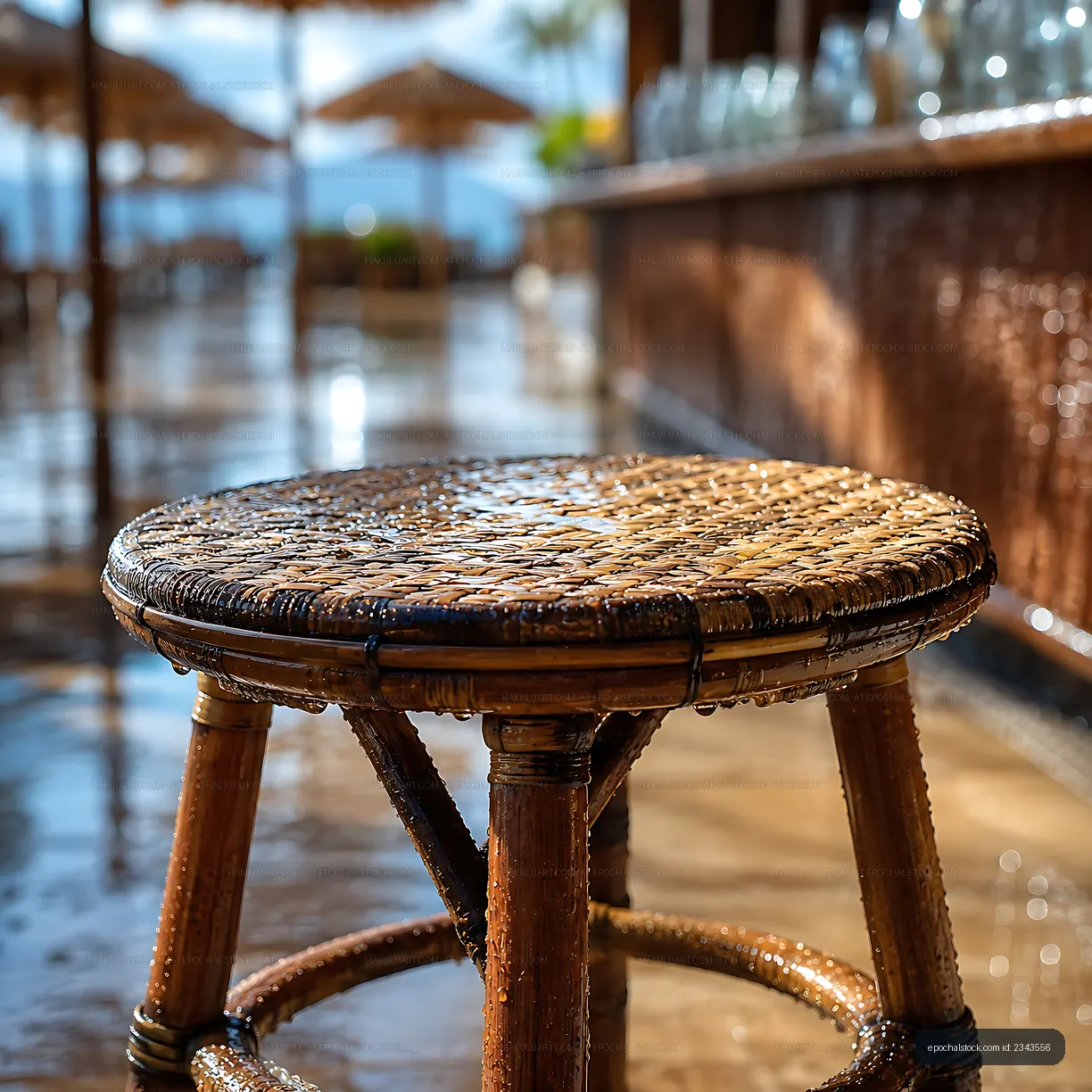 Wet wooden stool near beach bar on sunny day
