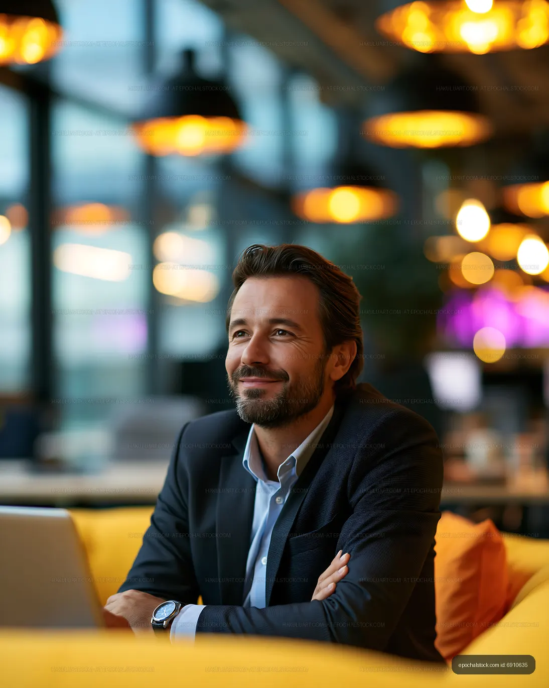 Man with beard sitting at a desk in a modern office