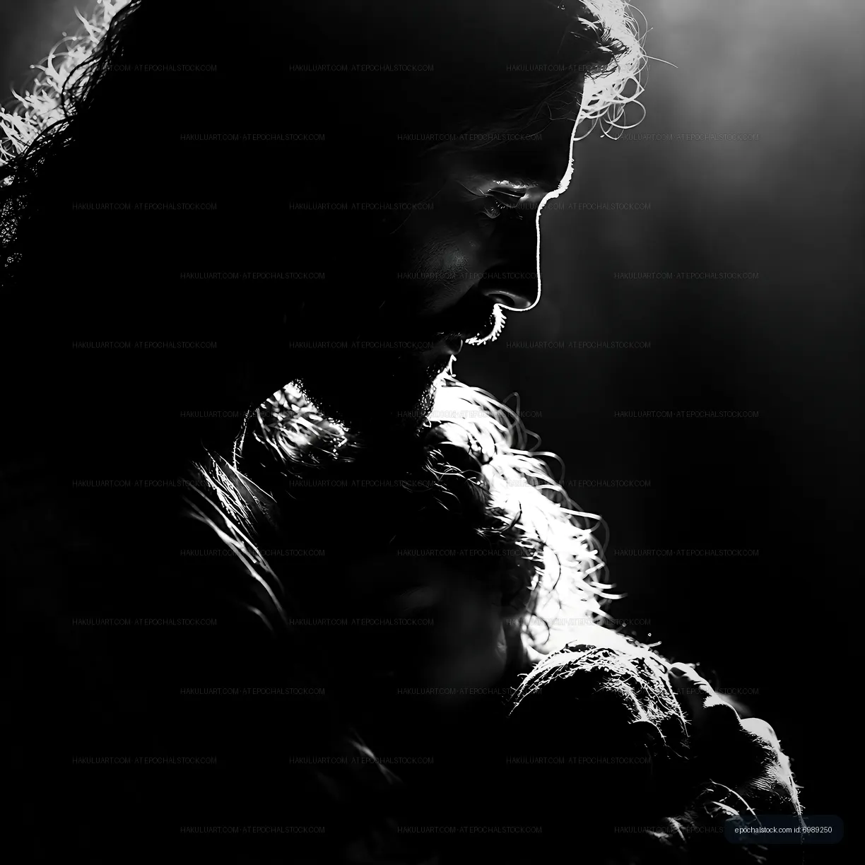 Silhouette of a man holding a child in low light