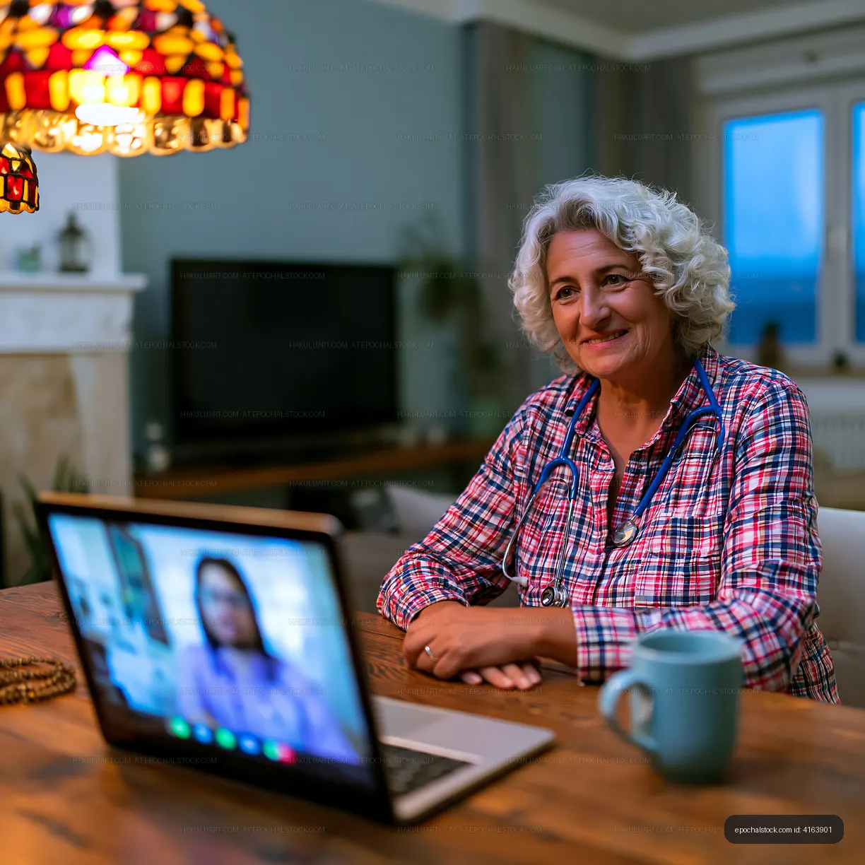 Senior woman having a video call at home with a laptop