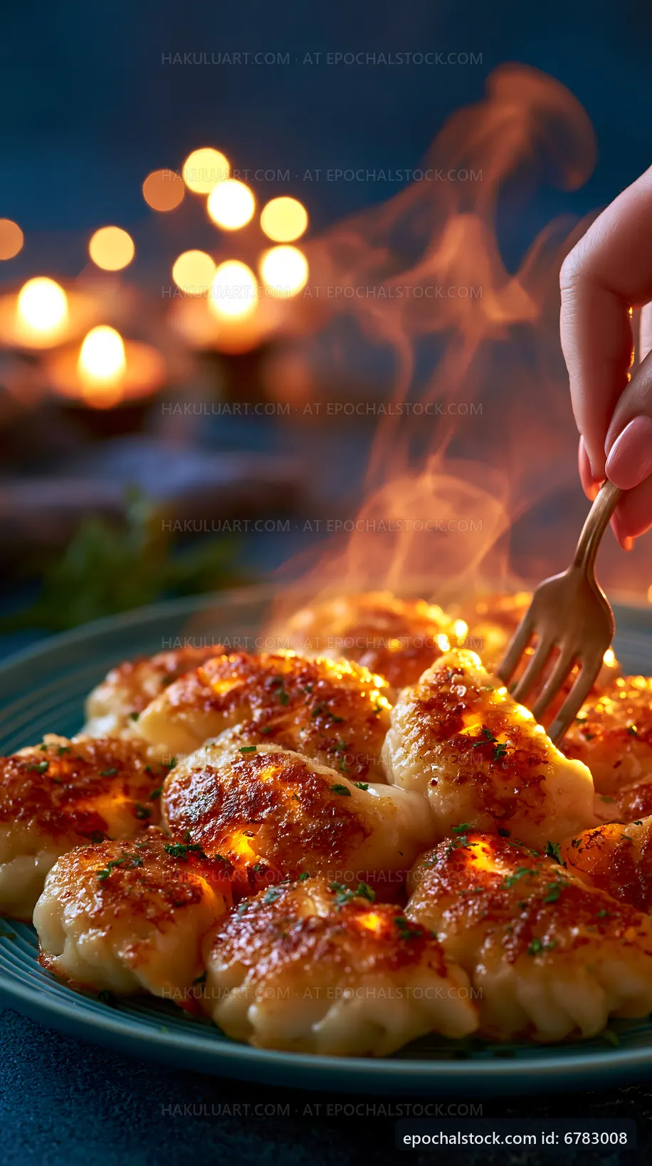 Hand holding a fork ready to serve golden brown dumplings