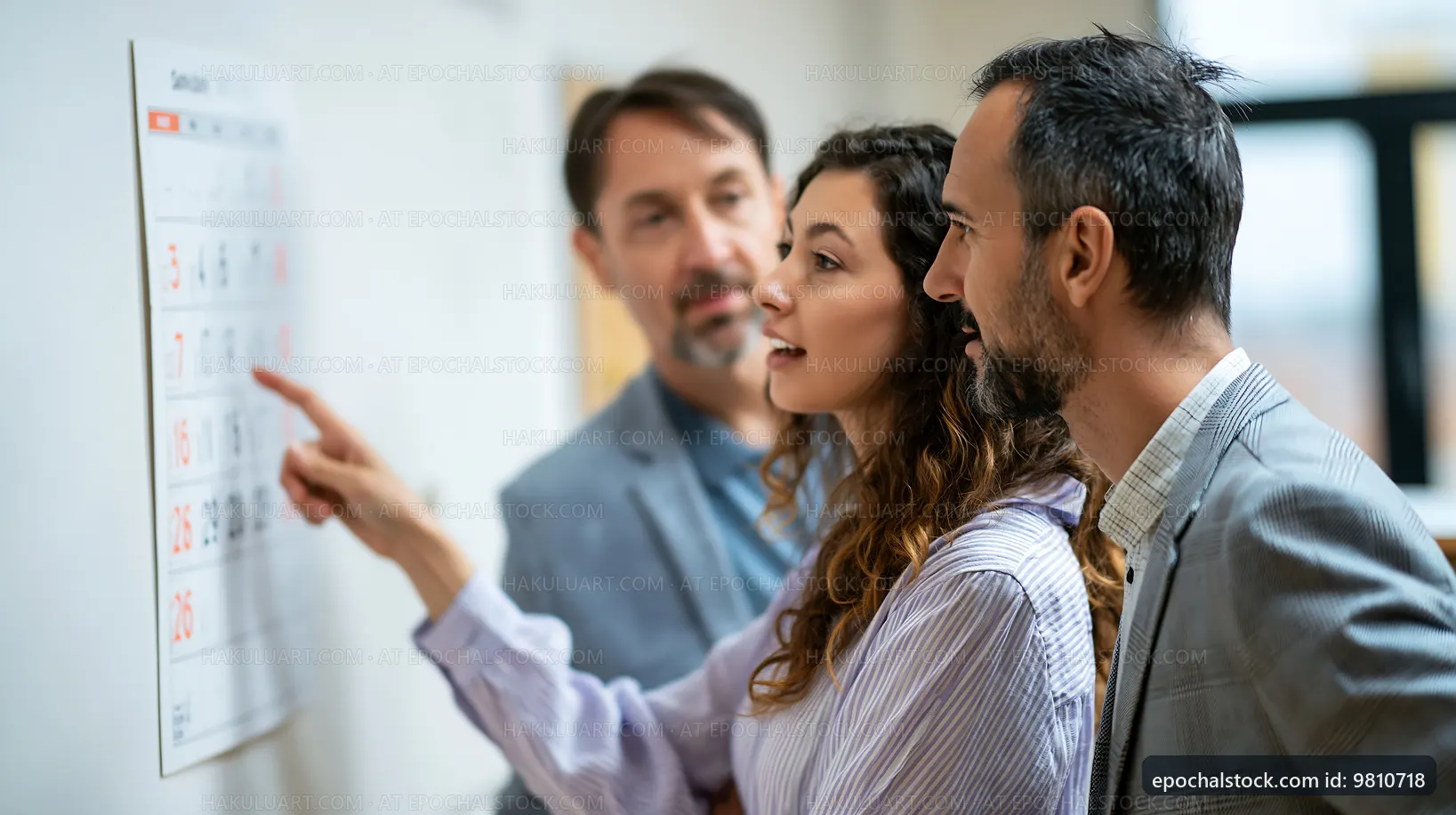 Team members discuss project deadlines at a workplace