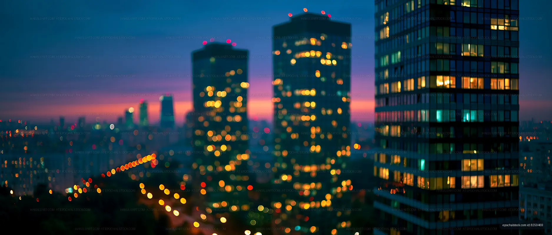 City skyline at dusk with glowing lights and blurred buildings