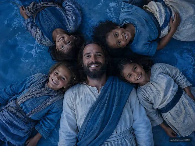 Group of smiling children and a man in blue clothing