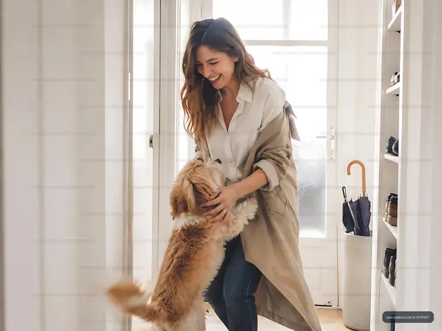 Woman playing with dog in hallway at home
