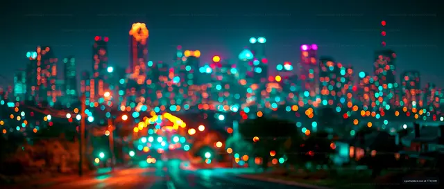 City skyline at night with colorful lights and blurred effect