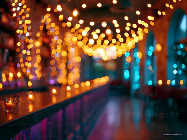 Warm lights illuminate a bar area in a cozy venue