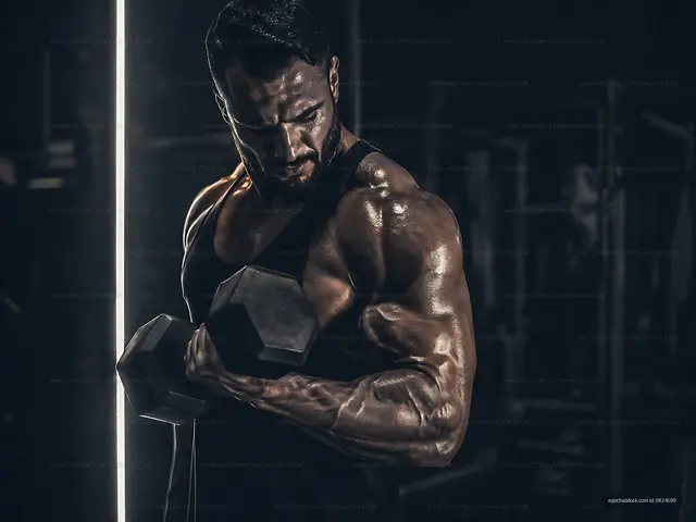 Muscle training with dumbbell in gym under dramatic lighting