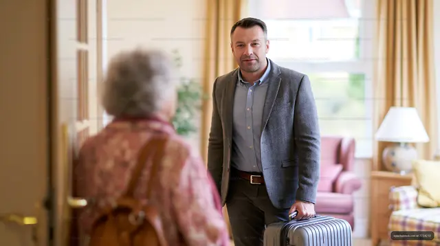 Man arrives home with suitcase to greet a woman