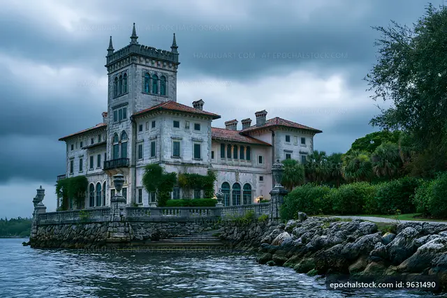 Historic mansion on the shores of a lake under cloudy sky