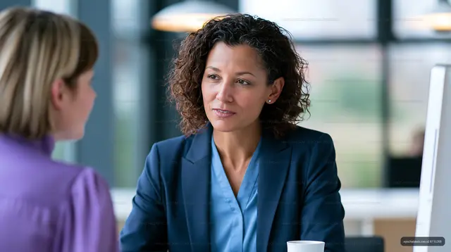 Two women in conversation during a business meeting in an office